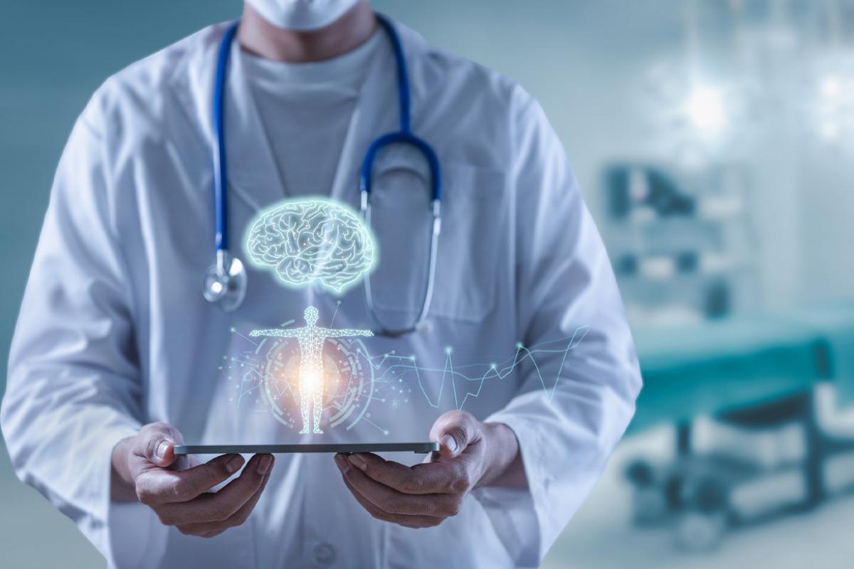 Doctor holding tablet showing brain human and body anatomy